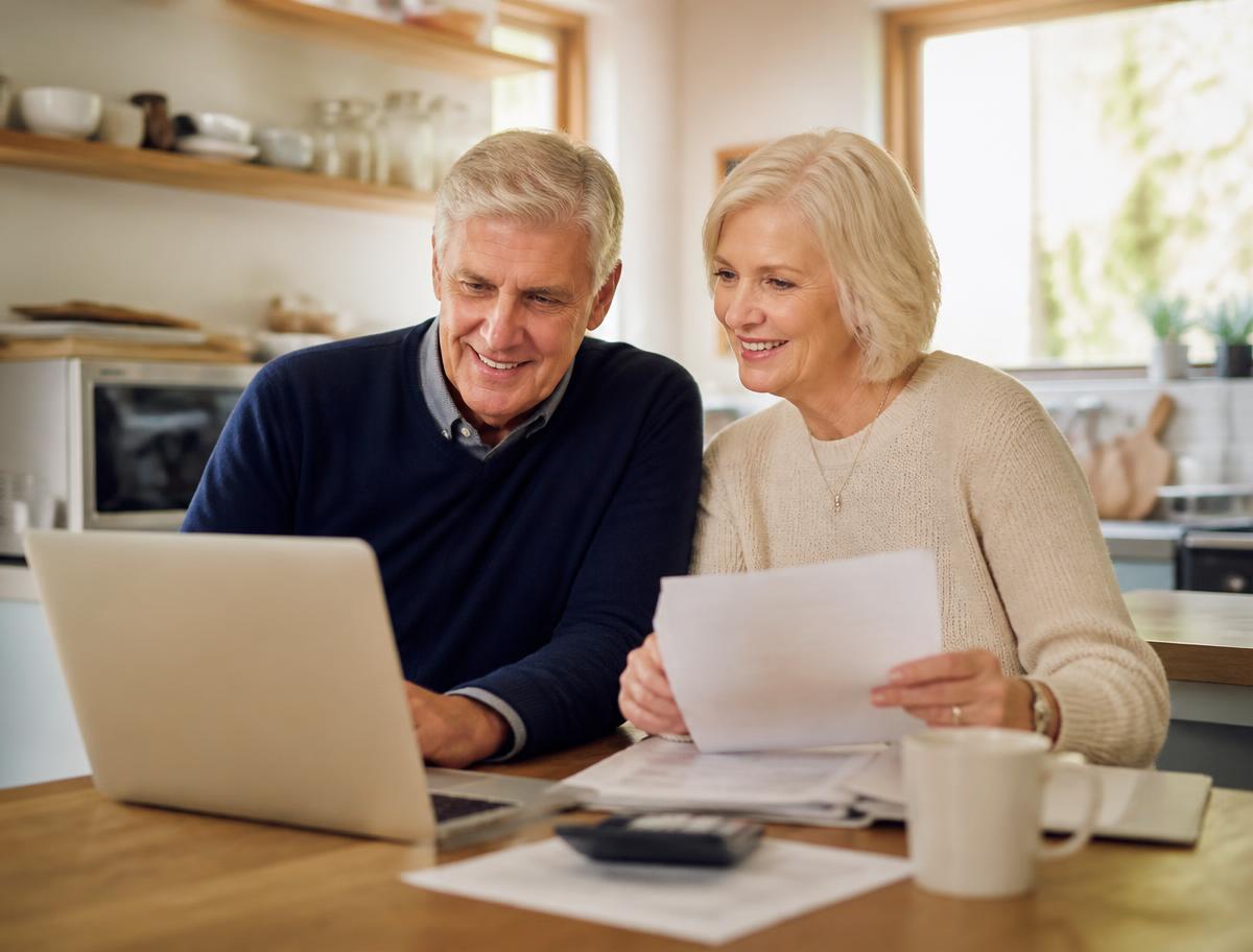 Couple in their sixties reviewing Medicare paperwork at home